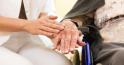 Young nurse and female senior in nursing home